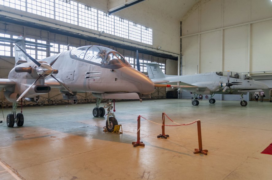 The ‘new’ Pucara Fenix configuration with its improved engine, four-bladed propellers, and EO/IR sensor turret can been seen in the foreground, while the now-retired light strike version is in the background. (Santiago Rivas)