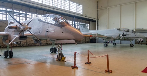 The 'new' Pucara Fenix configuration with its improved engine, four-bladed propellers, and EO/IR sensor turret can been seen in the foreground, while the now-retired light strike version is in the background.