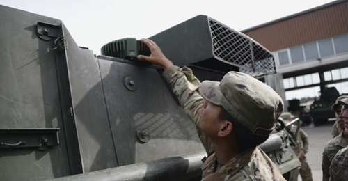 A US soldier checks part of a MAPS anti-jamming GPS device.