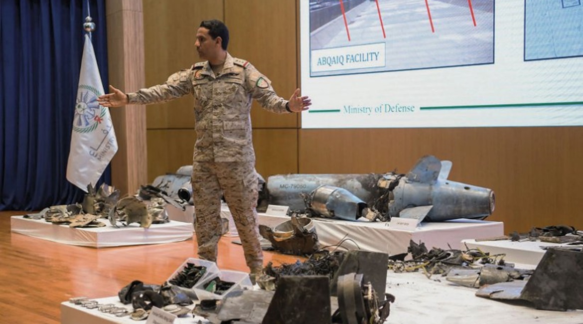 Saudi military spokesman Colonel Turki al-Maliki stands amongst the remnants of cruise missiles and UAVs recovered after the 14 September attacks on Saudi oil facilities.