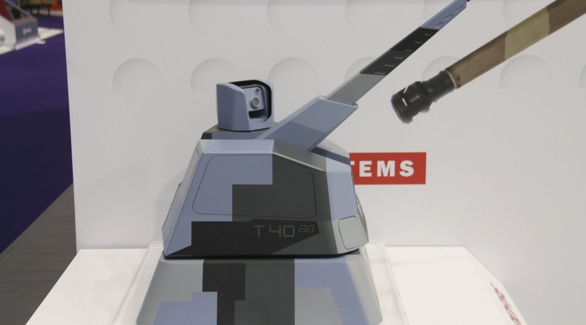 A scale model of the Thales/Nexter RAPIDFireNaval weapon system armed with a 40 mm Cased Telescoped Armament System, and showing the sensor pod mounted on the roof.