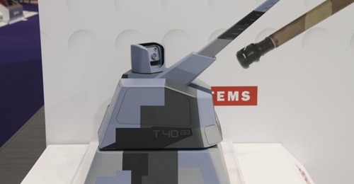 A scale model of the Thales/Nexter RAPIDFireNaval weapon system armed with a 40 mm Cased Telescoped Armament System, and showing the sensor pod mounted on the roof.