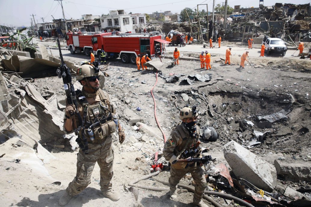 Afghan security forces near the crater left behind by a car bomb at the Green Village in Kabul on 3 September 2019. (STR/AFP/Getty Images )