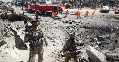 Afghan security forces near the crater left behind by a car bomb at the Green Village in Kabul on 3 September 2019.