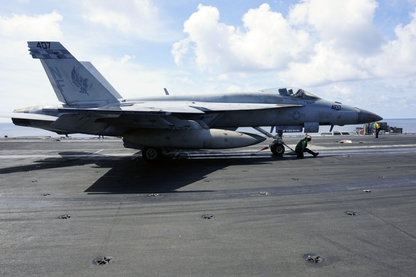 
        A catapult and arresting gear crew prepares an F/A-18 for take-off on USS
        Ronald Reagan
        .
       (IHS Markit/Ridzwan Rahmat)