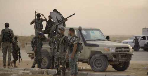 Syrian government troops are seen at Al-Tabqah Air Base, which was previously controlled by Kurdish forces, on 14 October.