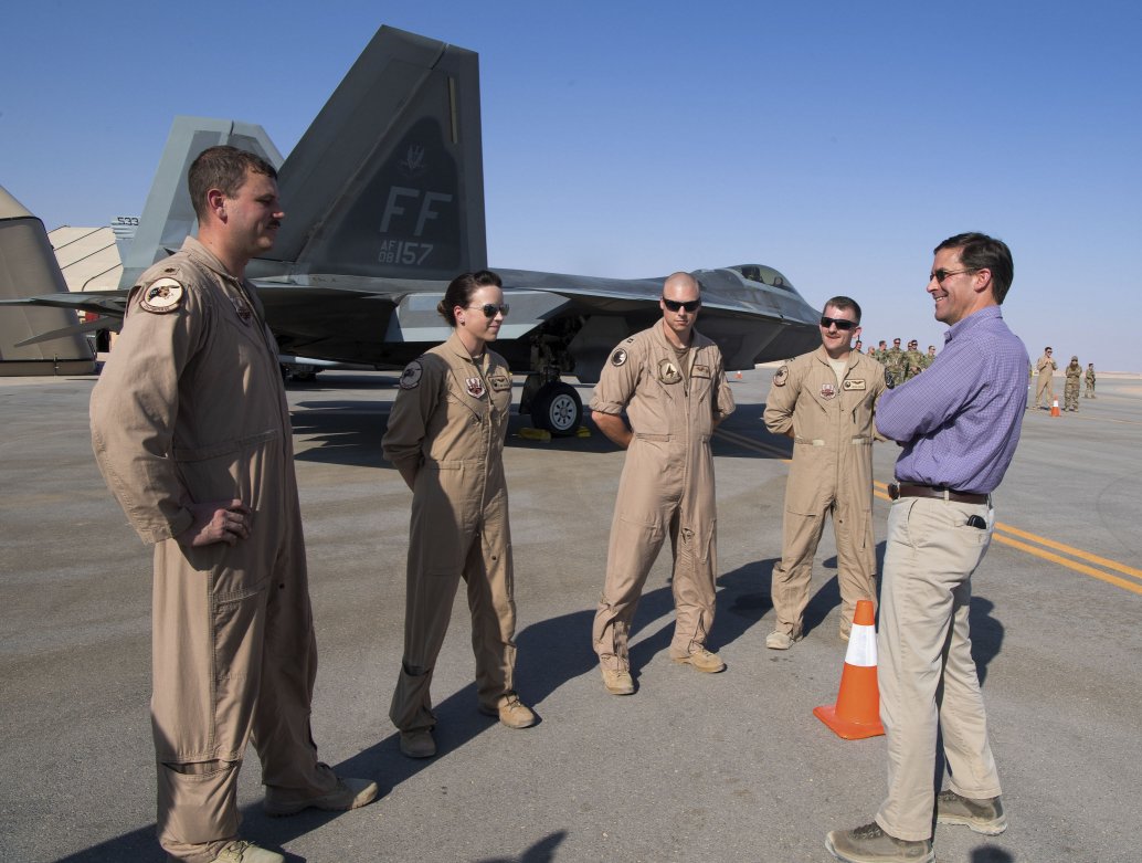 US Secretary of Defense Mark Esper talks to pilots in front of an F-22 Raptor at Prince Sultan Air Base on 22 October. (Office of the Secretary of Defense Public Affairs  )
