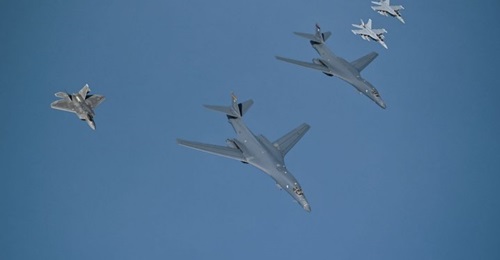 Two B-1B bombers are escorted over the Gulf by an F-22 Raptor and two EA-18G Growlers on their way to Prince Sultan Air Base in Saudi Arabia.