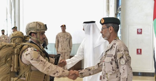 Lieutenant General Hamad Mohammed Thani al-Rumaithi, chief of staff of the UAE Armed Forces, shakes the hand of a soldier returning from Yemen.