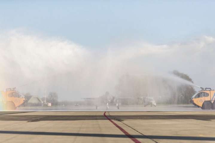 F-009 was welcomed into Leeuwarden Air Base with a traditional 'water' salute, though media reports and images showed the aircraft to have been  accidentally doused with fire retardant instead. (Royal Netherlands Air Force )