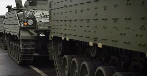 Warrior IFVs, sporting the baseline element of a modular armour package that can be tailored to specific threats, being loaded at the British Army's Ludgershall vehicle depot as part of the UK's 'Tractable' deployment.