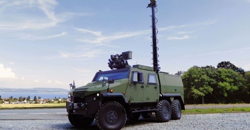 An Eagle 6×6 developed to meet Swiss army requirements, showing a protected four-door compartment, mast-mounted sensor pack, and Kongsberg remote weapon station.