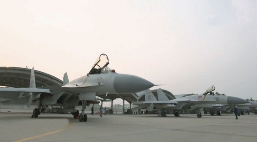 CCTV broadcast images in early November showing at least two PLANAF J-15 carrier-borne fighters at Huangdicun Airbase armed with what appear to be the KD-88 (fitted onto the aircraft in foreground) and YJ-91 missiles (fitted onto the aircraft to the right). (CCTV)
