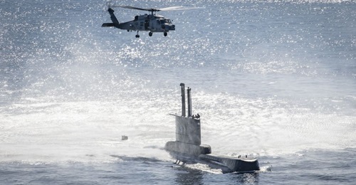An MH-60R Sea Hawk helicopter conducts a hoist exercise with Peruvian Navy submarine BAP 
        
         (SS-31).