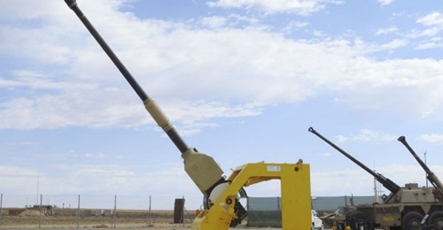 A G6 self-propelled howitzer with a 52-calibre gun (background) achieved the longest range ever attained with a conventional 155mm artillery round by firing it 76 km, while a PzH 2000 52-calibre gun (foreground) fired a shell 67 km at the Alkantpan tes...