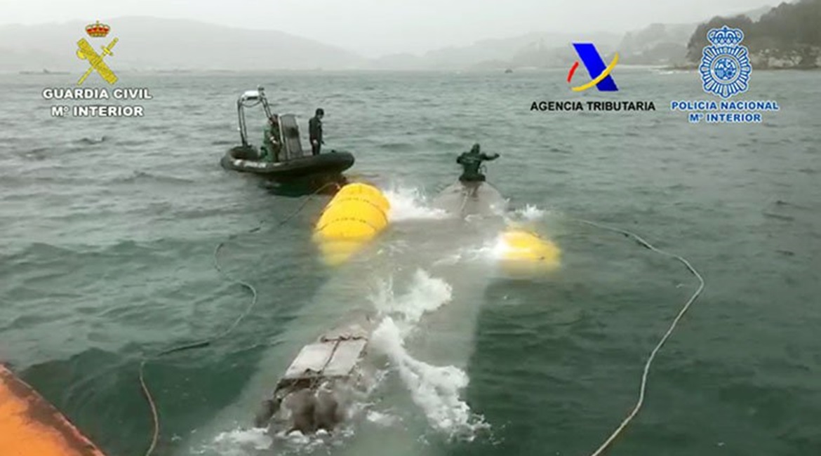 Personnel from the Spanish Guardia Civil refloating the 'narco-submarine' following its seizure.