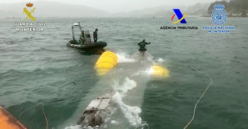 Personnel from the Spanish Guardia Civil refloating the 'narco-submarine' following its seizure.