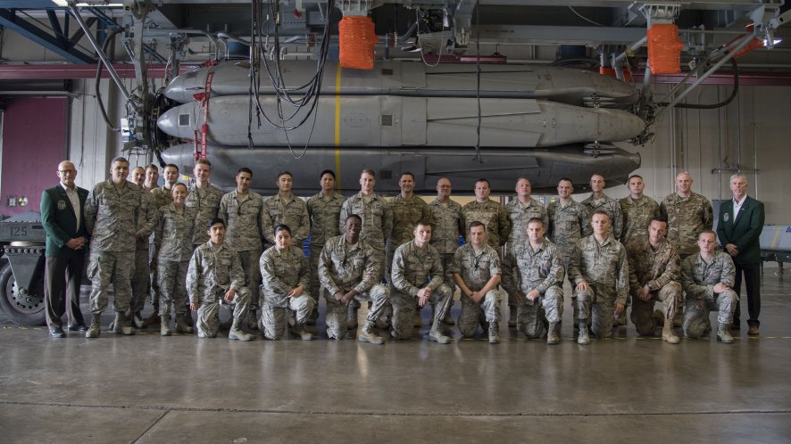 Current and retired service personnel from the 2nd Bomb Wing pose in front of the final Conventional Air-Launched Cruise Missile package at Barksdale Air Force Base, Louisiana, on 20 November. The CALCM missile package is being retired and replaced by the more advanced Long-Range Standoff (LRSO) weapon. (US Air Force)