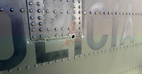 One of four 5.56 mm bullet holes in the tail of a Colombian National Police Sikorsky UH-60L Black Hawk helicopter. Since the bullet damaged vital structural components, Sikorsky Colombia is sending in a team to perform depot level repairs that the poli...