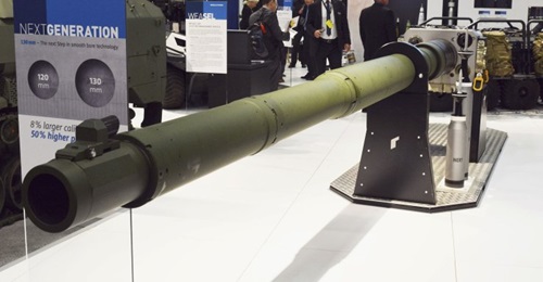 The Rheinmetall NG 130 mm tank gun is shown with two APFSDS rounds to the right. The first is a standard current 120 mm round with the second, to the rear, the much longer 130 mm round.