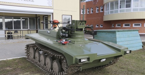The updated Marker unmanned ground vehicle seen with quadcopter UAVs.
