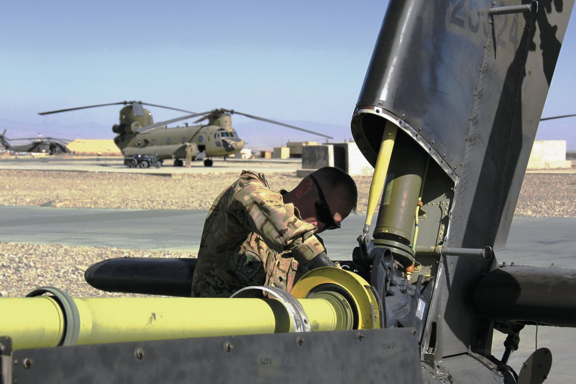 A US Army maintainer works on the drive chain of an Apache helicopter. The US DoD is looking to upgrade the tail-rotor systems of the Apache and other helicopters to cope with the increased power of the ITEP engine soon to be installed.