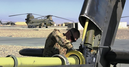 A US Army maintainer works on the drive chain of an Apache helicopter. The US DoD is looking to upgrade the tail-rotor systems of the Apache and other helicopters to cope with the increased power of the ITEP engine soon to be installed.
