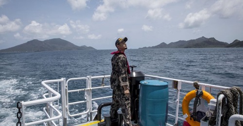 An Indonesian Ministry of Maritime Affairs and Fisheries official prepares to conduct security patrols in the Natuna Islands region
