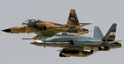 The twin-tailed Saeghe (foreground) in formation with an F-5F during military exercises. Iran fields a fighter force that is made up of either ageing types received from abroad, or domestically-developed types of questionable capabilities. it is doubtf...