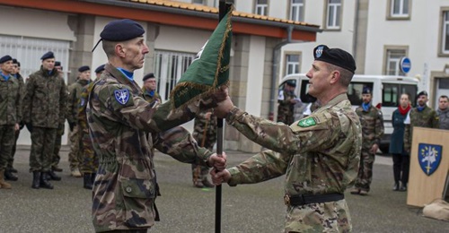 NATO's Allied Land Command Izmir commander, US Army Lieutenant General John Thomson (right), handing the NRF flag over to the Eurocorps commander, French Army Lieutenant General Laurent Kolodziej (left).