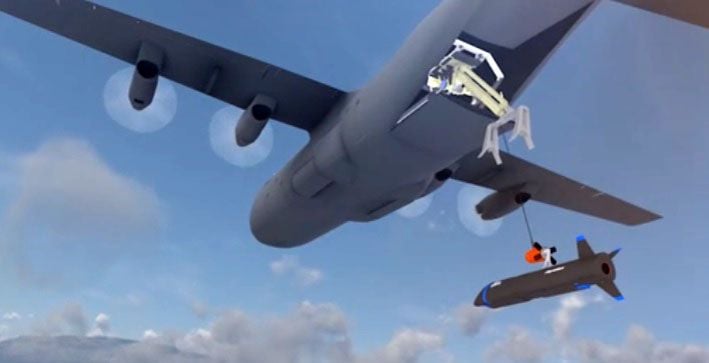 A screenshot from a US Air Force video showing one of two ways DARPA plans to aerial recover the X-61A. The other way is via a similar hose-and-drogue device positioned off the right wing of the C-130. (US Air Force)