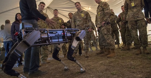 Jiren Parikh (foreground), Ghost Robotics CEO, briefs USAF service members on 18 December 2019 on the capabilities of the 'Robodogs' during a technology showcase for the Advanced Battle Management System (ABMS) demonstration at Eglin Air Force Base in ...