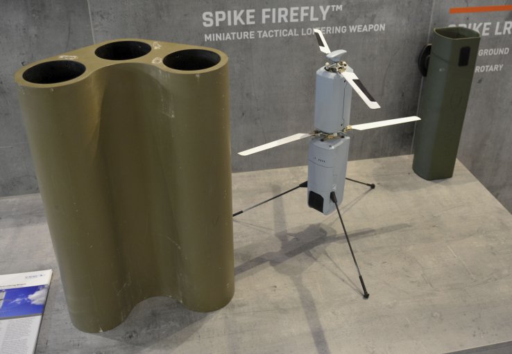 A Rafael Spike Firefly munition is pictured in the middle, with a three-munition launcher for vehicles on the left, and a transport canister for infantry on the right. (Janes/Patrick Allen)
