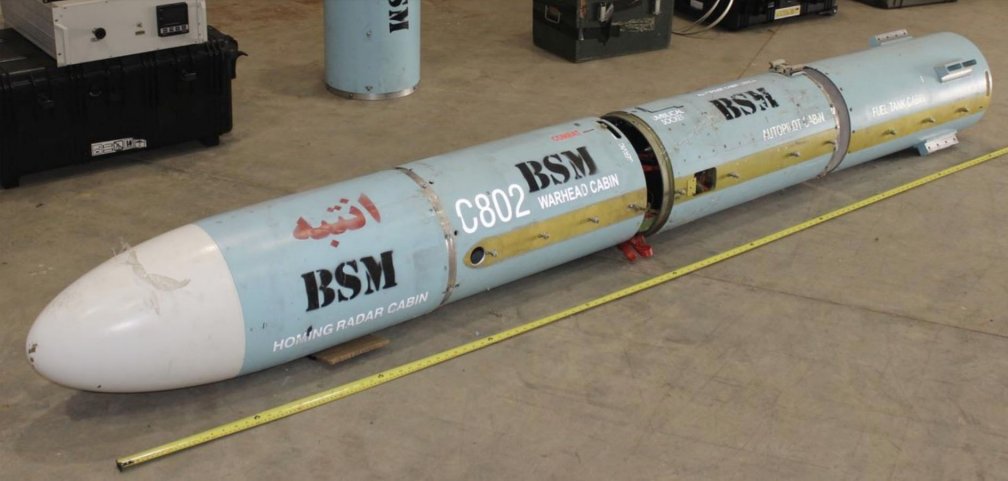 Four sections of the C802 anti-ship missile that was found on the dhow are seen lined up. The motor sections, wings, control surfaces, and conduits are not seen. The Arabic word for caution is written on the seeker section. (UN Panel of Experts on Yemen)