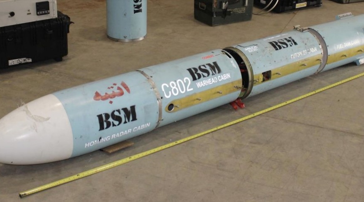 Four sections of the C802 anti-ship missile that was found on the dhow are seen lined up. The motor sections, wings, control surfaces, and conduits are not seen. The Arabic word for caution is written on the seeker section.