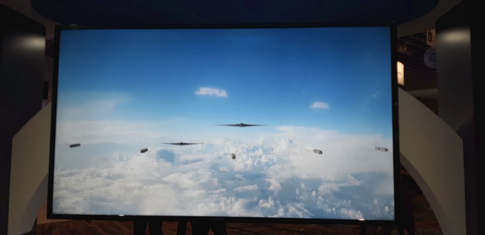 Aircraft that resemble the Northrop Grumman B-21 Raider and CSDB-1s fly during an attack simulation video on display on 28 February at the AFA Air Warfare Symposium. (Jane’s/Pat Host)