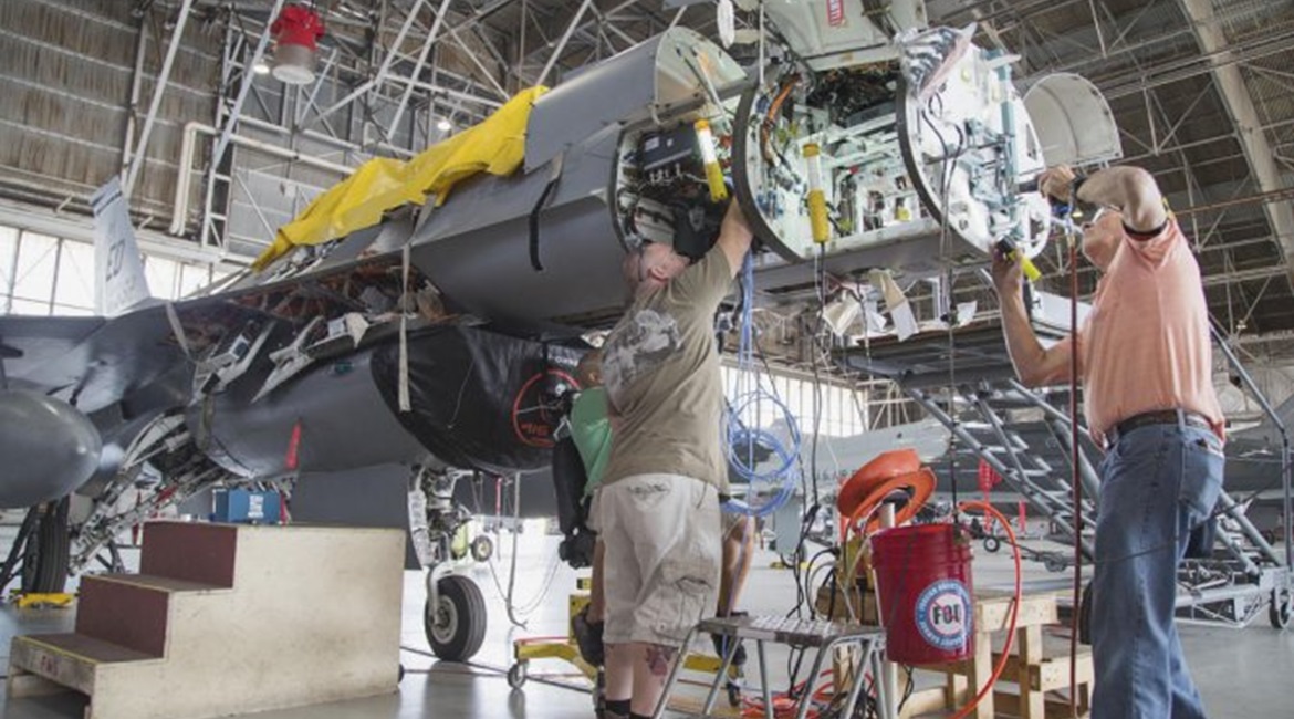 Maintenance personnel install mounting hardware for an APG-83 Scalable Agile Beam Radar on a 416th Flight Test Squadron F-16 Fighting Falcon during fitting trials. The USAF has now contracted Northrop Grumman to deliver 15 EMD and 90 production-standar...