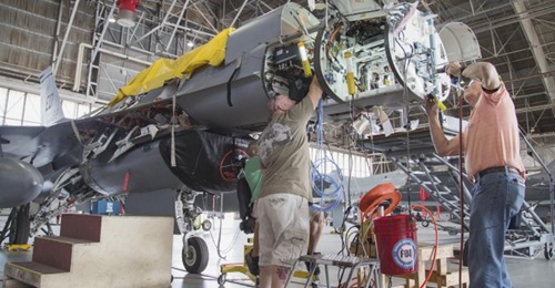 Maintenance personnel install mounting hardware for an APG-83 Scalable Agile Beam Radar on a 416th Flight Test Squadron F-16 Fighting Falcon during fitting trials. The USAF has now contracted Northrop Grumman to deliver 15 EMD and 90 production-standar...
