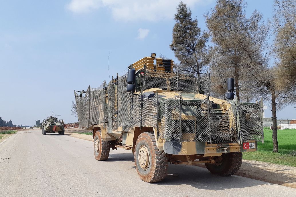 Turkish Kirpi and Russian BTR-80A armoured vehicles are seen carrying out the first joint patrol of the M4 highway in Idlib province on 15 March. The patrol’s route had to be shortened because of local demonstrations and militant threats. (Sergei Levanenkov\TASS via Getty Images)