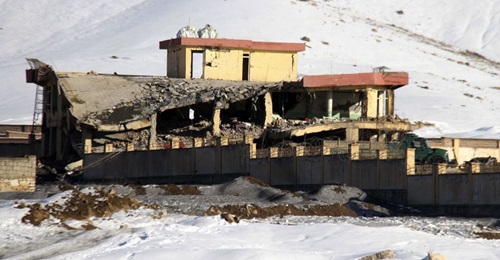 Afghan security officers secure the area of a collapsed building of the National Directorate of Security (NDS), following a Taliban attack, in Afghanistan's Wardak province on 21 January 2019.