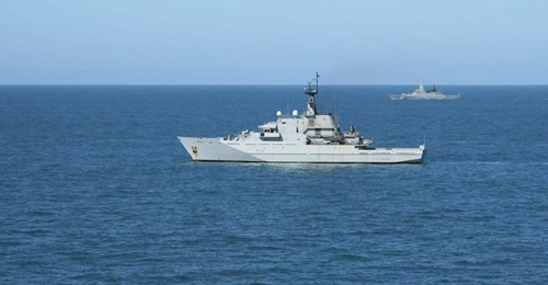 HMS 
        
         (foreground) shadowing the Russian corvette 
        
         (background) in waters around the UK.