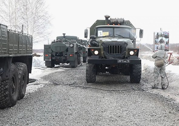 Russian CBRN protection troops decontaminate military vehicles during a readiness exercise on 25–28 March. (Russian MoD)
