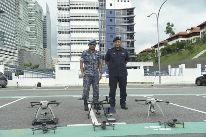 Malaysian Chief of Defence Force General Affendi Buang and Inspector General of Police Hamid Bador with the unmanned systems that have been deployed for enforcing the Movement Control Order in Malaysia. (Malaysian Armed Forces)
