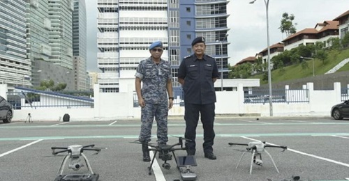 Malaysian Chief of Defence Force General Affendi Buang and Inspector General of Police Hamid Bador with the unmanned systems that have been deployed for enforcing the Movement Control Order in Malaysia.