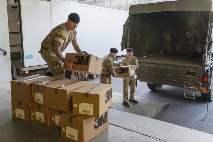 UK military personnel delivering boxes of PPE face masks to St Thomas Hospital in London on 24 March. (MoD Crown Copyright)