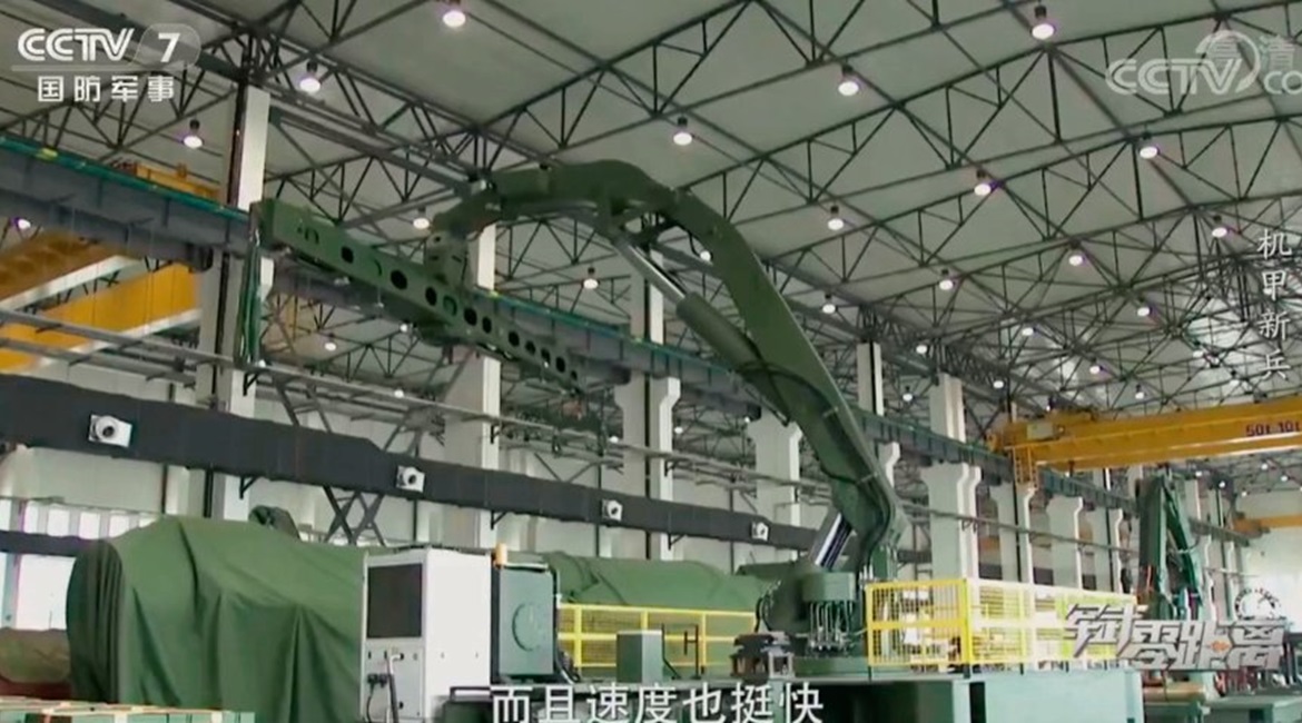 A screen grab from a CCTV 7 video showing what the broadcaster described as a “large, crane-like robot that can be used in lifting and loading missiles onto transporter-erector launchers”. The system is reportedly entering service with the ...