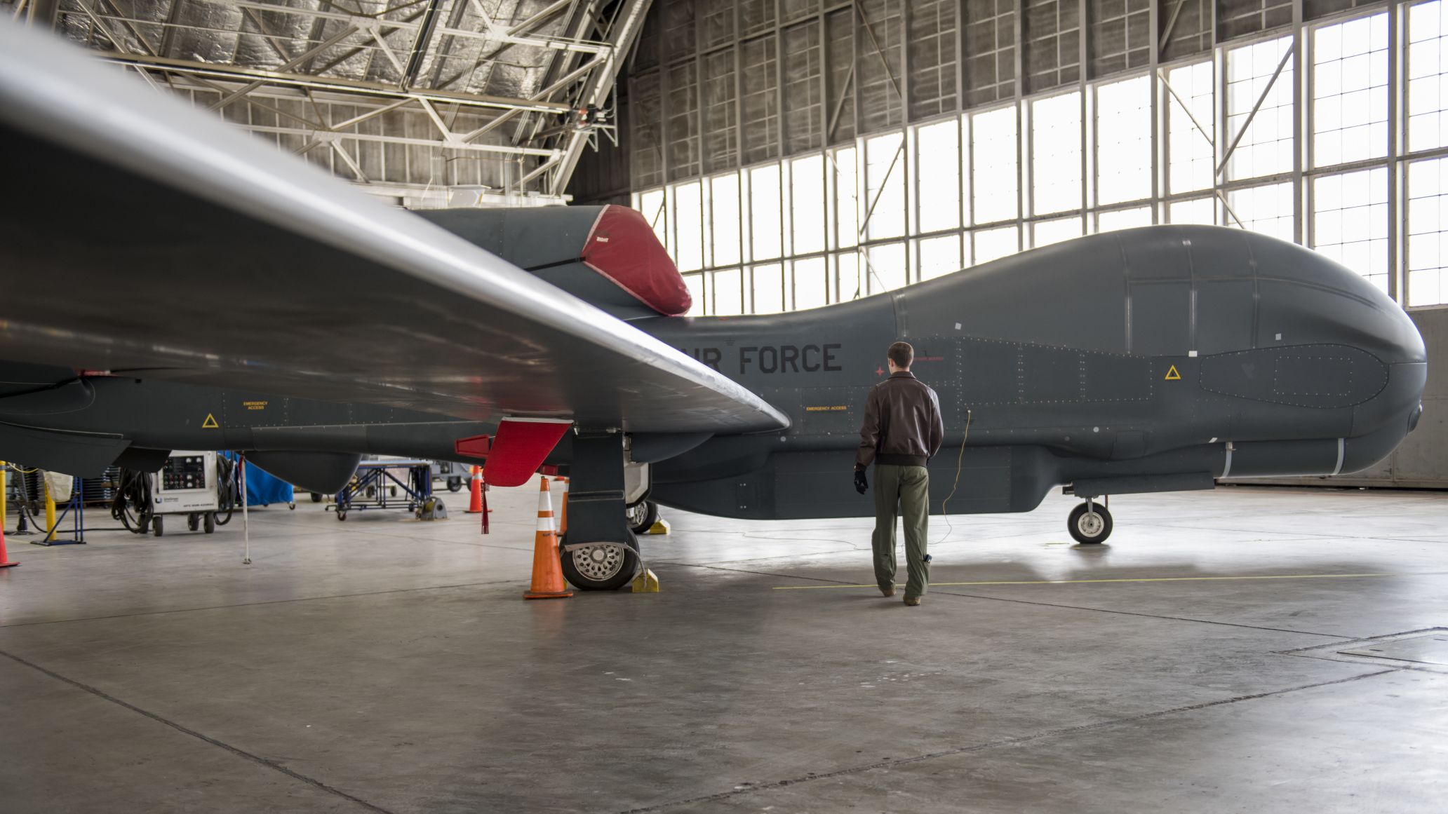 A US Air Force airman on a walk-through inspection of an RQ-4 Global Hawk UAV on 6 April 2020. A new report proposes the US use existing UAVs such as the Global Hawk to better perform ISR missions to help deter aggression by China and Russia. (US Air Force)