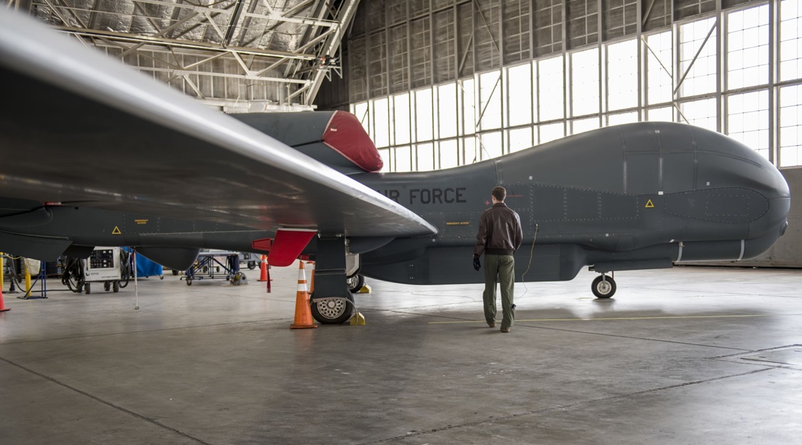 A US Air Force airman on a walk-through inspection of an RQ-4 Global Hawk UAV on 6 April 2020. A new report proposes the US use existing UAVs such as the Global Hawk to better perform ISR missions to help deter aggression by China and Russia.