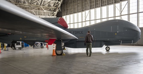 A US Air Force airman on a walk-through inspection of an RQ-4 Global Hawk UAV on 6 April 2020. A new report proposes the US use existing UAVs such as the Global Hawk to better perform ISR missions to help deter aggression by China and Russia.