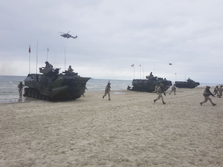 Spanish marines and armoured amphibious assault vehicles, deployed from the US Navy’s Whidbey Island-class LSD amphibious assault ship USS Fort McHenry, come ashore on Palanga Beach, Lithuania, in an amphibious demonstration during ‘BALTOPS 2019’. Due to Covid-19, USEURCOM is weighing if it will cancel the maritime exercise this year. (Lee Willett)